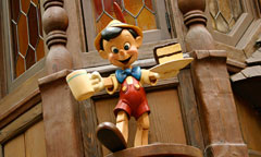 Wooden Pinocchio with a Mug and Plat of Cake in Hand at Village Haus Restaurant, hosted by Minute Maid