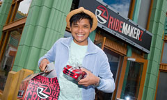 Man Holding a Model Car in Front of RIDEMAKERZ