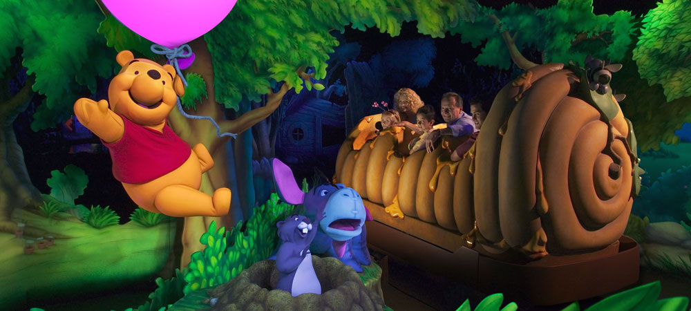 Guests Enjoying The Many Adventures of Winnie the Pooh Attraction