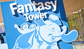 The Fantasy Tower sign with an illustration of a child riding The Dumbo the Flying Elephant attraction