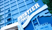 The Frontier Tower sign with an illustration of the Mark Twain Riverboat attraction.