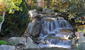 A small falls fills a landscaped area near the Frontier Tower.