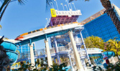 A view from below of water slides, platform and Disneyland sign.