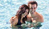 A couple enjoys a calm moment in the water.
