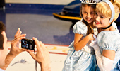 Cinderella and a young girl pose for a photo.