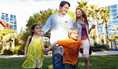 A family of 4 walks through the Disneyland Hotel courtyard.