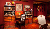Writing desk, surrounded by maps, globes and curios.