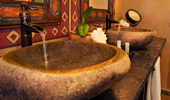 Stone-work sinks and old-fashioned-pump-looking faucet.