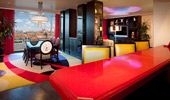 A view of the Suite from behind a bright red bar. 