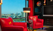 Mickey's pants inspire the design of a pair of red leather parlor chairs with double yellow buttons as decoration. 