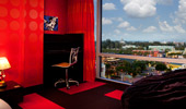 The The red, yellow and black-themed bedroom provides a panoramic view over the Resort.