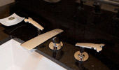 Faucet fixtures in the shape of a famous mouse.