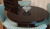 Dark wood round table surrounded by 4 dining chairs
