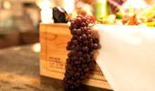 Close up of a cluster of grapes in a decorative wooden box.