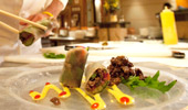 A chef artfully arranges a specialty dish.