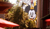 Through the trees, see the iconic face of Mickey Mouse on Mickey's Fun Wheel, a Disney California Adventure Park attraction.
