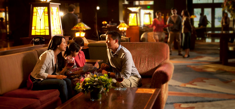 A family discusses the day while seated on the cozy lobby couches.