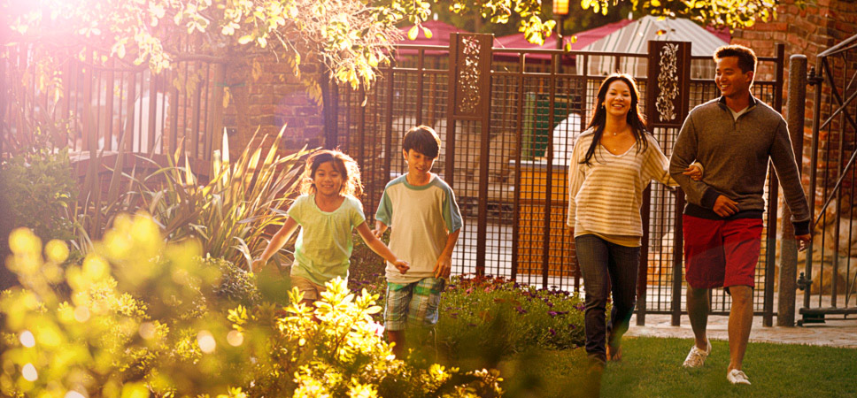 A family of 4 enjoys a walk in the sunshine and gorgeous gardens.