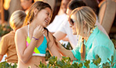 A mother and daughter share a touching moment by the pool.