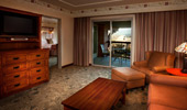 Living area of the one-bedroom Artisan Suite, with couches, chairs and television.