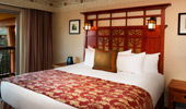 Shot of a king-size bed with wooden headboard