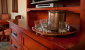 Water glasses, ice bucket and tray placed on the gorgeous media console.