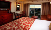 From the king-size bed see the TV, dresser and exit to balcony.