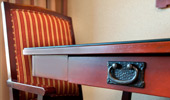 Close up on drawer-pull detail on a writing desk