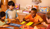 4 young Guests play a board game.