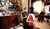 A Mandara Spa attendant discusses the available services with a Guest.
