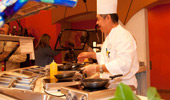 A chef cooks up his creations at the egg and omelet station.