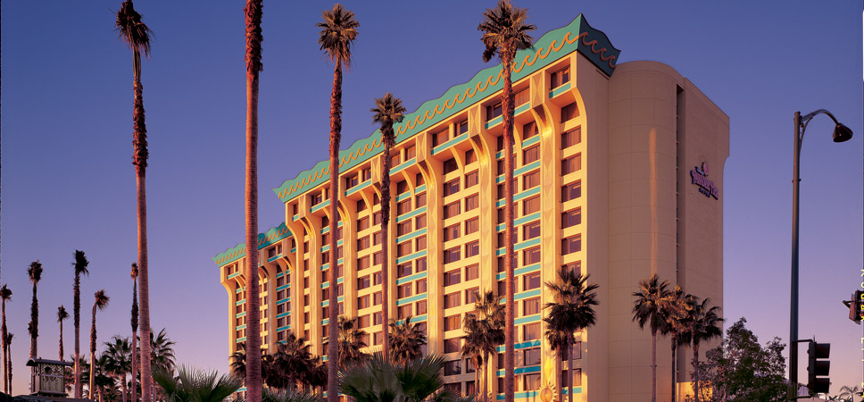 Exterior shot with palm trees and Disney's Paradise Pier Hotel, complete with wave design