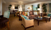High bar chairs are positioned by the counter, which is near the living area.