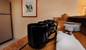 Coffee mugs are lined up on the bar and ready for the morning.