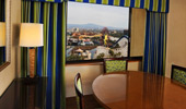 Dining table and chairs are positioned near a window with a Theme Park view.