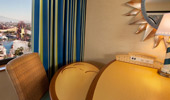A bright yellow computer table with a lighthouse lamp