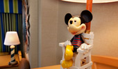 A delightful desk lamp has a base with Mickey Mouse on a life guard's chair.